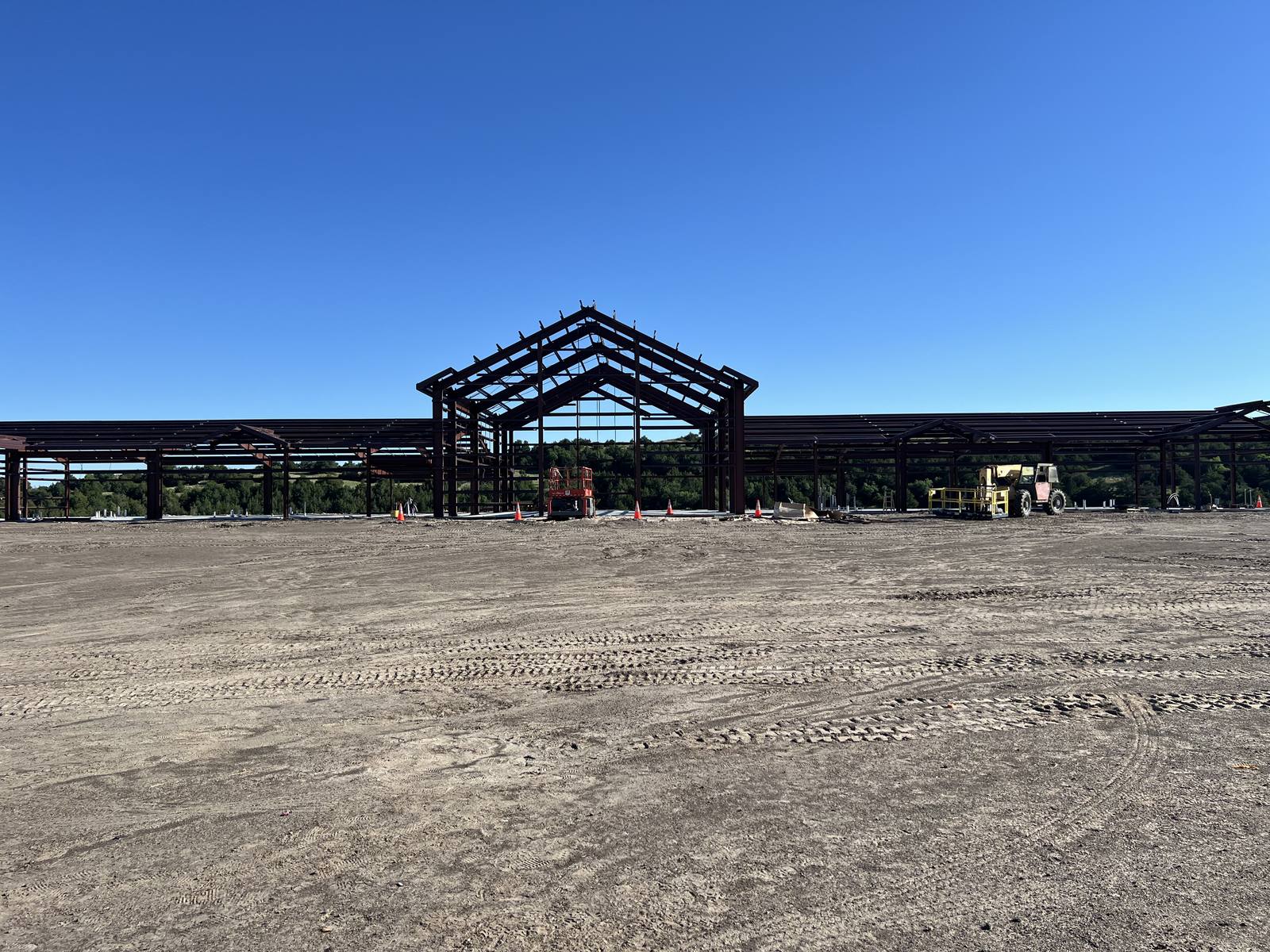 Tall gable steel frames going up on a sandy site near Mullen, Nebraska