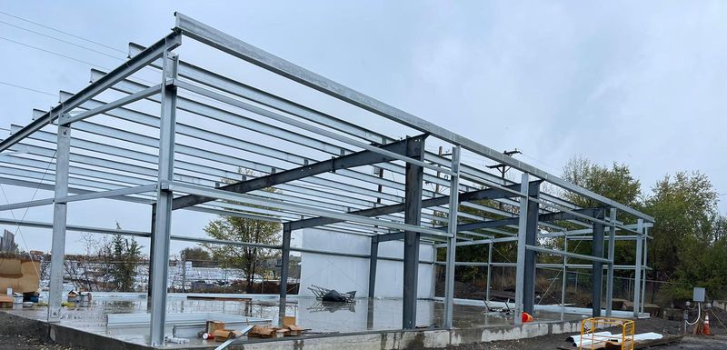 Long gray steel frame with purlins and girts on its slab in Littleton, Colorado
